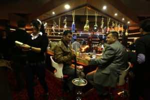 Customers enjoy the view from the rooftop bar of Baghdad's Palestine Hotel, on February 9, 2013 (AFP-File, Patrick Baz)