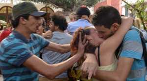 Moroccan Facebook users stage a kiss-in in front of the parliament (AFP Photo)