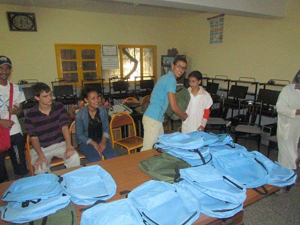 The American Language Center in Fez donating school bags for young Moroccan students in Fez. Photo by Yahya Bouhafa for Morocco World News
