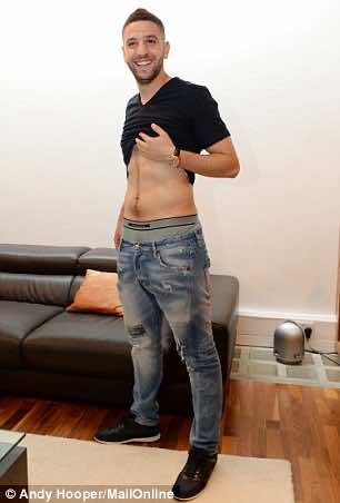 Taarabt shows off his physique to Sportsmail photographer Andy Hooper in response to Redknapp's insults