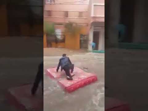 Man Rides Mattress on Flooded Streets of Guelmim