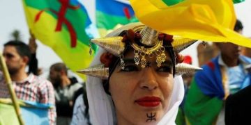 Amazigh women wearing traditional head jewelry.