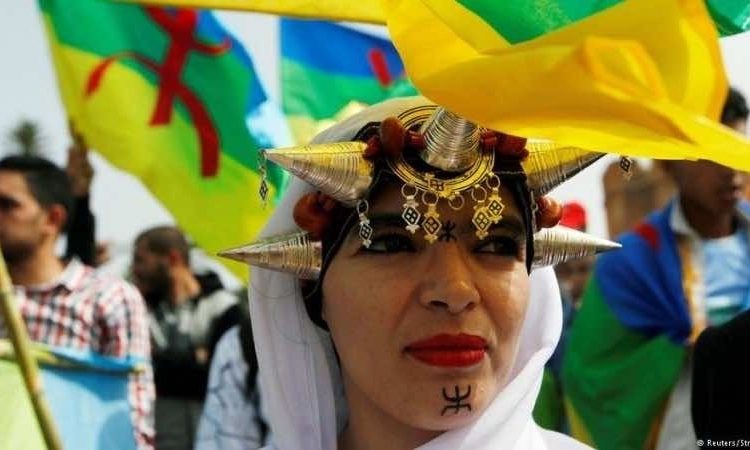 Amazigh women wearing traditional head jewelry.