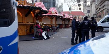 Police officers stand at a cordoned-off Christmas Market