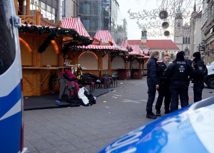 Police officers stand at a cordoned-off Christmas Market