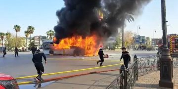 Firefighters rushing to extinguish fire on a bus in Fez