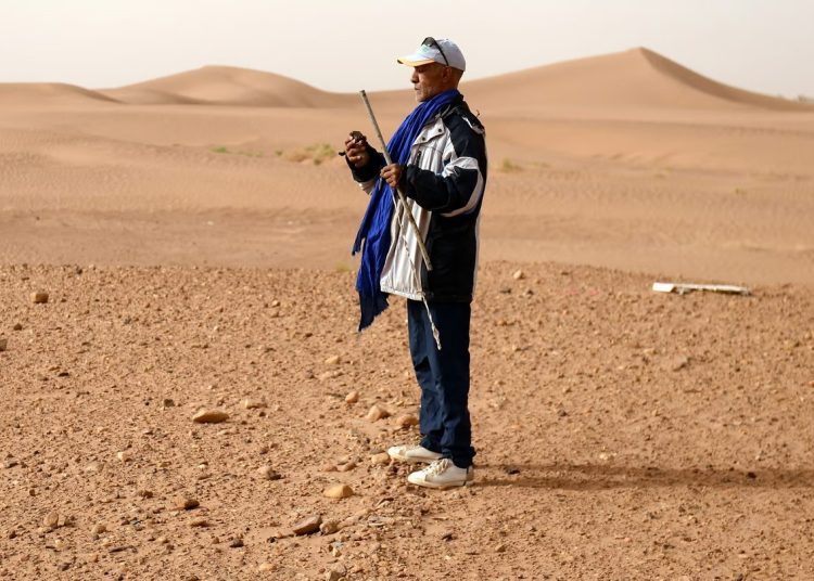 Moroccan nomad scans endless Sahara dunes for precious cosmic stones. Photo: Fadel Senna / Getty Images