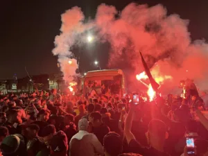 Fans celebrating after bus carrying the players arrived in Dcheira