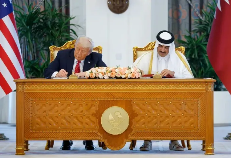 US President Donald Trump and Qatar’s Emir Sheikh Tamim bin Hamad Al signign agreements. Reuters