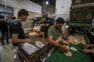 Workers package bread for distribution at the World Food Programme (WFP) bakery after a limited amount of flour entered the Gaza Strip, where border crossings have remained closed since March 2 due to an Israeli aid blockade, in Deir el-Balah, Gaza [Ali Jadallah/Anadolu]