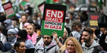 Demonstrators march through the streets against Israeli strikes in Gaza and Lebanon in the central business district of Sydney, Australia. [Saeed Khan/AFP]