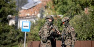 Polish soldiers in Wyryki after a drone hit a home during Russia’s Ukraine attack, September 10. (Jakub Orzechowski/Agencja Wybo/Reuters)