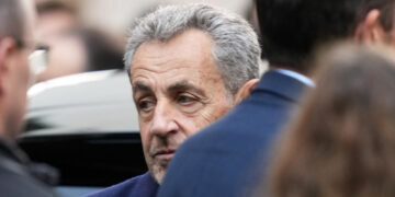 Former French president Nicolas Sarkozy entering a police car that drove him to the La Santé prison in Paris for his five-year sentence on October 21, 2025. © Thibault Camus, AP