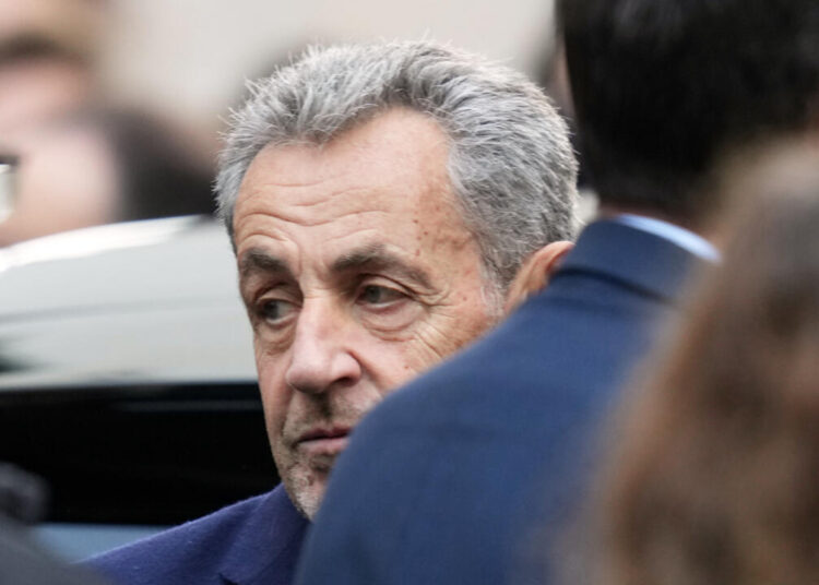 Former French president Nicolas Sarkozy entering a police car that drove him to the La Santé prison in Paris for his five-year sentence on October 21, 2025. © Thibault Camus, AP