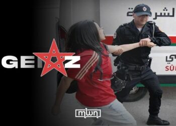 A police man dragging a female protester during a Gen Z demonstration