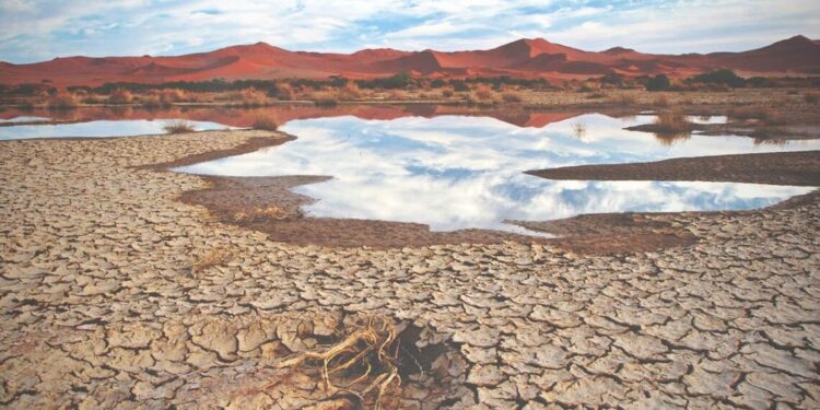 A parched landscape and dwindling water reflect the growing impact of climate change and global warming.