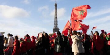 Participants of all ages marched through the French capital waving Moroccan flags and holding photos of King Mohammed VI