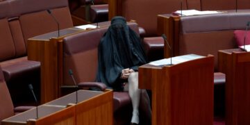 One Nation leader Pauline Hanson sits in her seat after entering the senate chamber. Photo: Dominic Lorrimer/Sydney Morning Herald