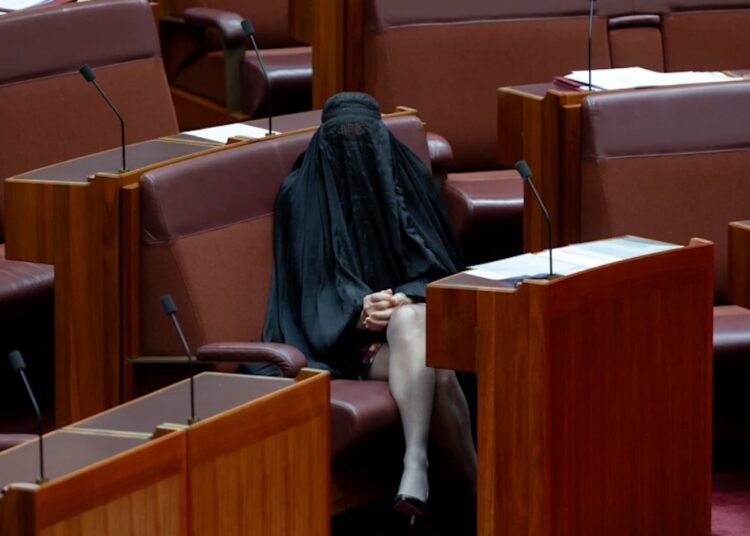 One Nation leader Pauline Hanson sits in her seat after entering the senate chamber. Photo: Dominic Lorrimer/Sydney Morning Herald