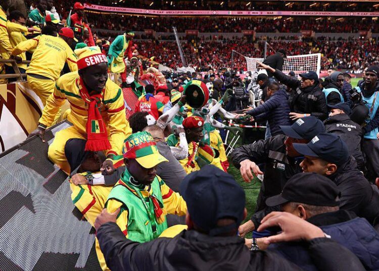 Hundreds of Senegalese supporters attempted to storm the pitch for nearly 17 minutes before security forces regained control.