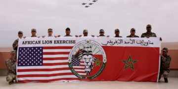 US Marines and soldiers from the Royal Moroccan Armed Forces (FAR) pose for a group photo while F16 fighter jets pass overhead at Cap Draa during African Lion 25 (AL25) in TanTan, Morocco, May 23, 2025.