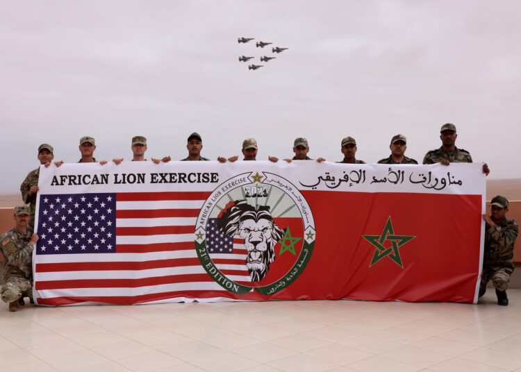 US Marines and soldiers from the Royal Moroccan Armed Forces (FAR) pose for a group photo while F16 fighter jets pass overhead at Cap Draa during African Lion 25 (AL25) in TanTan, Morocco, May 23, 2025.