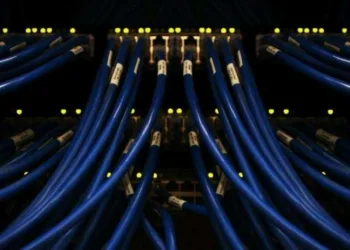Data cables connected on network switches in a computer server room. Scott Rodgerson on Unsplash.