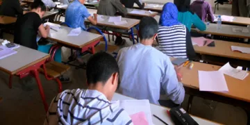 Students sit for exams in a classroom during an assessment session.