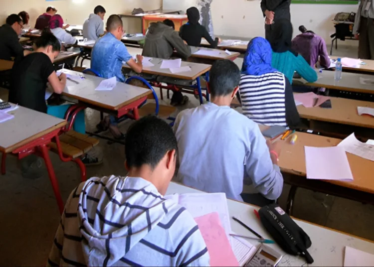 Students sit for exams in a classroom during an assessment session.