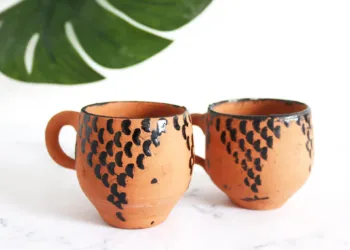 Tar gives pottery its characteristic dark streaks, black rims, and dotted patterns.