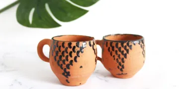Tar gives pottery its characteristic dark streaks, black rims, and dotted patterns.