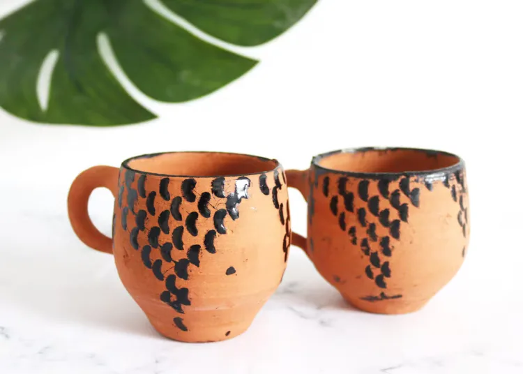 Tar gives pottery its characteristic dark streaks, black rims, and dotted patterns.