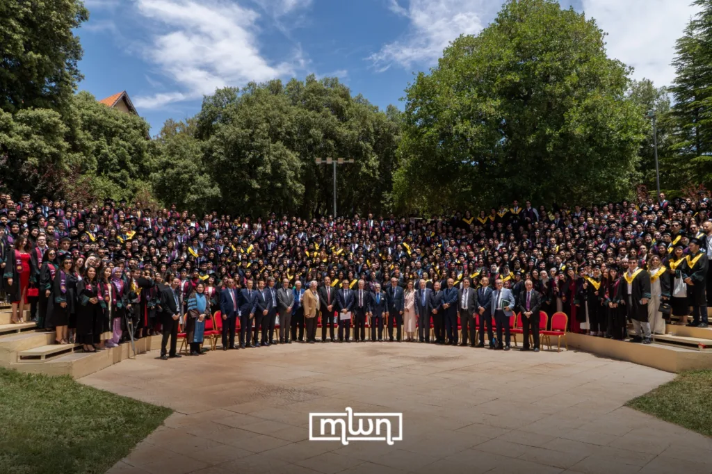 AUI graduates gather outdoors with members of the Board of Trustees during the university’s 29th cohort celebration in Ifrane