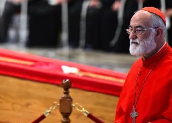 Cardinal Cristóbal López Romero, Archbishop of Rabat, walks beside the coffin of Pope Francis after paying tribute during a ceremony inside St. Peter’s Basilica at the Vatican on April 23, 2025. © AFP