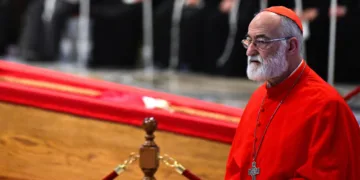 Cardinal Cristóbal López Romero, Archbishop of Rabat, walks beside the coffin of Pope Francis after paying tribute during a ceremony inside St. Peter’s Basilica at the Vatican on April 23, 2025. © AFP