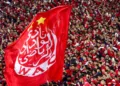 Supporters hold a giant Wydad's flag as they attend the CAF Champions league's match between Wydad Casablanca and Zamalek at the Mohammed V Stadium, in Casablanca, on February 26, 2022, after the reopening of the football fields in Morocco. (Photo by AFP)