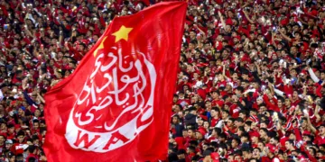 Supporters hold a giant Wydad's flag as they attend the CAF Champions league's match between Wydad Casablanca and Zamalek at the Mohammed V Stadium, in Casablanca, on February 26, 2022, after the reopening of the football fields in Morocco. (Photo by AFP)