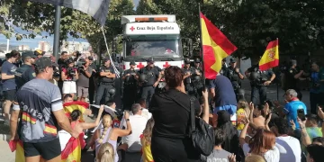 Residents waving Spanish flags marched through the enclave, chanting for the migrants to leave and trying to block Red Cross vehicles from delivering food.