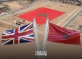 Moroccan and British flags pictured against an aerial backdrop of Western Sahara featuring a giant Moroccan flag. (Designed by MWN team)