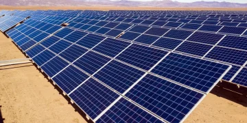 Solar panels stretch across an arid landscape in Morocco.