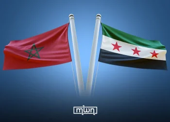 Illustration showing the flags of Morocco and Syria side by side against a blue background. (Designed by MWN team)