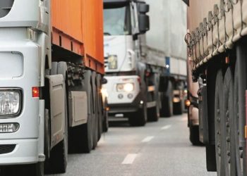 Heavy trucks line a roadway.