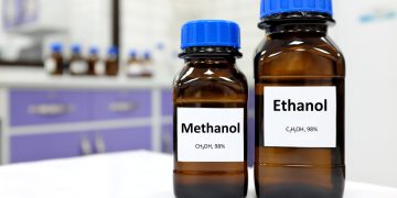 Laboratory bottles labeled methanol and ethanol, illustrating the distinction between the toxic alcohol and the type found in alcoholic beverages.
