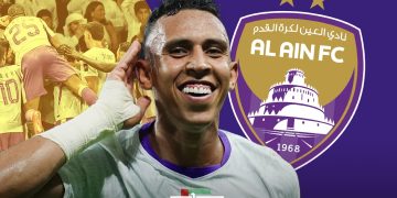 A graphic featuring Moroccan footballer Soufiane Rahimi in an Al Ain FC jersey, with the club’s logo and a cheering crowd in the background, by MWN Design Team.