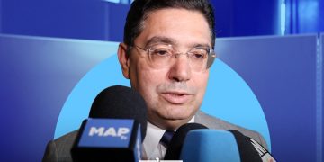 A graphic featuring Moroccan Foreign Minister Nasser Bourita speaking to the media, by MWN Design Team.