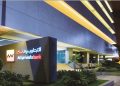 Attijariwafa Bank’s headquarters in Morocco, illuminated at night, with the bank’s logo prominently displayed on the building’s exterior.