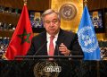 UN Secretary-General António Guterres pictured at the UN General Assembly podium alongside the Moroccan and United Nations flags. (Designed by MWN team)