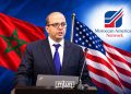 US-based Moroccan journalist Mohamed El Hajjam speaking at a podium, with Moroccan and American flags and the Moroccan American Network logo in the background. (Designed by MWN team)
