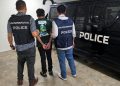 Officers participating in Operation Confrontation Ghost arrest a suspect during an international crackdown on AI-powered fraud networks.
