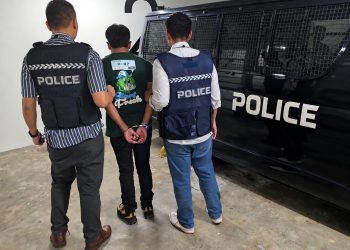 Officers participating in Operation Confrontation Ghost arrest a suspect during an international crackdown on AI-powered fraud networks.